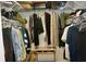 Well-organized walk-in closet with ample storage space and varied hanging clothes at 8735 Sw 192Nd Court Rd, Dunnellon, FL 34432