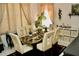 Bright dining room with a glass table, six chairs, and neutral decor at 8735 Sw 192Nd Court Rd, Dunnellon, FL 34432