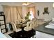 Bright dining room with a glass table, six chairs, and neutral decor at 8735 Sw 192Nd Court Rd, Dunnellon, FL 34432