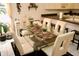 Bright dining room with glass table, chairs, and view to the kitchen with counter seating at 8735 Sw 192Nd Court Rd, Dunnellon, FL 34432
