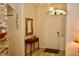 Bright entryway featuring a wooden mirror, console table and front door with transom window at 8735 Sw 192Nd Court Rd, Dunnellon, FL 34432