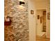 Welcoming entryway features a decorative stone accent wall and a glimpse into an adjacent bathroom at 8735 Sw 192Nd Court Rd, Dunnellon, FL 34432