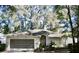 Charming single-story home with well-maintained landscaping, a screen garage, and an arched entryway at 8735 Sw 192Nd Court Rd, Dunnellon, FL 34432