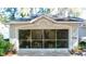 Attached two-car garage with a screened garage door system, revealing ample storage space at 8735 Sw 192Nd Court Rd, Dunnellon, FL 34432