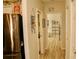 View of a hallway featuring wood-look floors, a stainless steel refrigerator, and a white storage unit with storage cubes at 8735 Sw 192Nd Court Rd, Dunnellon, FL 34432