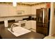 Bright kitchen featuring a stainless steel refrigerator and white appliances at 8735 Sw 192Nd Court Rd, Dunnellon, FL 34432