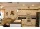 Well-lit kitchen with black countertops, modern appliances, and view of the dining area at 8735 Sw 192Nd Court Rd, Dunnellon, FL 34432
