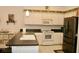 Charming kitchen featuring sleek appliances, white cabinetry, and contrasting countertops for a modern aesthetic at 8735 Sw 192Nd Court Rd, Dunnellon, FL 34432