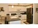 Functional kitchen with ample counter space, white appliances, and a convenient layout at 8735 Sw 192Nd Court Rd, Dunnellon, FL 34432