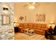 Comfortable living room featuring a large leather couch, and light wood flooring at 8735 Sw 192Nd Court Rd, Dunnellon, FL 34432