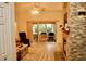 Cozy living room featuring an indoor/outdoor area, wood flooring, and a stone fireplace at 8735 Sw 192Nd Court Rd, Dunnellon, FL 34432