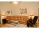 Spacious living room with a large sectional couch, light wood floors, and modern decor at 8735 Sw 192Nd Court Rd, Dunnellon, FL 34432