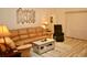 Cozy living room featuring a large leather couch and an accent chair at 8735 Sw 192Nd Court Rd, Dunnellon, FL 34432