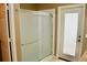Modern shower with frosted glass door next to a bright exterior door that provides natural light at 8735 Sw 192Nd Court Rd, Dunnellon, FL 34432