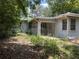 Exterior rear view of a single story home and an overgrown yard at 922 Se 13Th St, Ocala, FL 34471