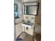 A bathroom showcasing a sink, toilet and mirror with beige tile at 922 Se 13Th St, Ocala, FL 34471