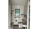 A bathroom with vintage black and white tile, toilet and sink at 922 Se 13Th St, Ocala, FL 34471