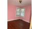 Bedroom with hardwood floors, baseboard trim, and simple window with mini blinds at 922 Se 13Th St, Ocala, FL 34471