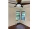 Bedroom with hardwood flooring, corner windows and ceiling fan at 922 Se 13Th St, Ocala, FL 34471