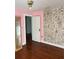 A bedroom with hardwood floors, pink walls, and a wall covered in comic strip panels at 922 Se 13Th St, Ocala, FL 34471