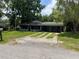 Exterior front view of a single story home with a driveway and mature trees at 922 Se 13Th St, Ocala, FL 34471