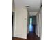 Hallway with light walls and hardwood floors looking towards the green backyard at 922 Se 13Th St, Ocala, FL 34471