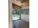 Enclosed sun room with sliding glass door, wood ceiling, ceiling fan and weathered tile floor at 922 Se 13Th St, Ocala, FL 34471
