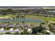 An aerial view of the community with a lake and the golf course is stunning at 9511 Sw 71St Loop, Ocala, FL 34481