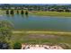 This beautiful backyard view overlooks a peaceful pond and manicured lawn at 9511 Sw 71St Loop, Ocala, FL 34481
