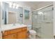 Bathroom featuring wood cabinetry, a glass enclosed shower, and a decorative window at 9511 Sw 71St Loop, Ocala, FL 34481