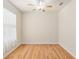 Bright bedroom featuring wood floors, a ceiling fan, and a large window with natural light at 9511 Sw 71St Loop, Ocala, FL 34481