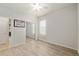 This well-lit bedroom has hard surface floors, a window, and mirrored closet doors at 9511 Sw 71St Loop, Ocala, FL 34481