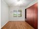 Bedroom with laminated wood flooring, ceiling fan, and large window with a view at 9511 Sw 71St Loop, Ocala, FL 34481
