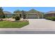 Charming home featuring a three-car garage, well-manicured lawn and landscaping at 9511 Sw 71St Loop, Ocala, FL 34481