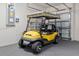 Bright garage with a yellow golf cart at 9511 Sw 71St Loop, Ocala, FL 34481