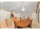 Bright kitchen with an island, granite counters, stainless appliances, and adjacent dining area with decorative chandelier at 9511 Sw 71St Loop, Ocala, FL 34481