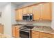Kitchen with stainless appliances, granite countertops and wooden cabinets at 9511 Sw 71St Loop, Ocala, FL 34481