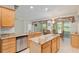 Bright kitchen with stainless appliances, granite counters, wooden cabinets, and a breakfast nook with a view at 9511 Sw 71St Loop, Ocala, FL 34481