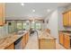Bright kitchen with an island, stainless appliances, granite counters, and a view to the dining area at 9511 Sw 71St Loop, Ocala, FL 34481