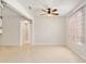 Spacious living room with neutral walls, tile flooring, ceiling fan and lots of natural light at 9511 Sw 71St Loop, Ocala, FL 34481