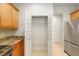 Walk-in pantry with shelving providing plenty of storage space next to stainless fridge at 9511 Sw 71St Loop, Ocala, FL 34481