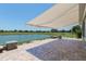 A covered brick patio with a view of a scenic lake at 9511 Sw 71St Loop, Ocala, FL 34481