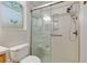 Close-up of the accessible shower with glass doors and decorative window at 9511 Sw 71St Loop, Ocala, FL 34481
