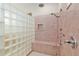 Shower featuring glass block wall, shower bench, shower head and tile surround at 9511 Sw 71St Loop, Ocala, FL 34481