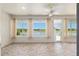 Bright sunroom with tile flooring and lake views through large windows at 9511 Sw 71St Loop, Ocala, FL 34481
