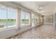 Sunroom with tiled floors overlooking a peaceful lake at 9511 Sw 71St Loop, Ocala, FL 34481
