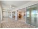 Spacious sunroom with glass doors leading to a kitchen and lake view at 9511 Sw 71St Loop, Ocala, FL 34481