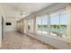 Sunroom with tiled floor and a scenic lake view at 9511 Sw 71St Loop, Ocala, FL 34481