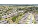 Vast aerial view of a community boasting numerous homes with manicured lawns and tree-lined streets in a serene setting at 9658 Sw 76Th Lane Rd, Ocala, FL 34481