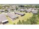 Wide aerial view of a residence showcasing a backyard with a screened lanai and a beautifully landscaped lawn at 9658 Sw 76Th Lane Rd, Ocala, FL 34481